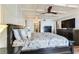 Primary bedroom with a coffered ceiling, tv, and ensuite bathroom at 5353 Gulf Blvd # A402, St Pete Beach, FL 33706