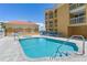 Beautiful community pool and spa area with lounge chairs at 5353 Gulf Blvd # A402, St Pete Beach, FL 33706