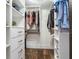 Spacious walk-in closet with custom shelving, drawers, and ample hanging space for organized storage at 5353 Gulf Blvd # A402, St Pete Beach, FL 33706