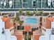 Aerial view of a condo complex featuring a beautiful courtyard pool and a marina with docks at 610 Pinellas Bayway S # 5202, Tierra Verde, FL 33715
