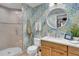 Updated bathroom featuring decorative wallpaper, shower and wood vanity at 610 Pinellas Bayway S # 5202, Tierra Verde, FL 33715