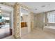 Bathroom featuring a glass shower and wallpapered vanity at 610 Pinellas Bayway S # 5202, Tierra Verde, FL 33715