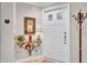Elegant foyer featuring a decorative table, palm tree artwork, and a white door that is well-lit at 610 Pinellas Bayway S # 5202, Tierra Verde, FL 33715