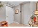 Bright hallway features a white door, elevator access, and decorative accents for a welcoming entrance at 610 Pinellas Bayway S # 5202, Tierra Verde, FL 33715