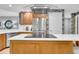 Modern kitchen boasting stainless steel appliances, a center island with a cooktop, and ample counter space for cooking and entertaining at 610 Pinellas Bayway S # 5202, Tierra Verde, FL 33715