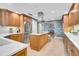 Open kitchen featuring custom cabinets, island with cooktop, stainless steel appliances, and stylish decor for an elegant culinary experience at 610 Pinellas Bayway S # 5202, Tierra Verde, FL 33715
