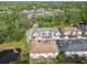Scenic aerial view of home in a leafy neighborhood, backing to a peaceful pond at 6825 Citrus Creek Ln, Tampa, FL 33625