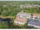Overhead view of townhomes near a pond surrounded by trees at 6825 Citrus Creek Ln, Tampa, FL 33625