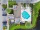A bird's eye view of the pool, surrounded by ample lounging space, landscaping, and parking provides an overview of community amenities at 6825 Citrus Creek Ln, Tampa, FL 33625