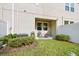 Private backyard features a patio area with seating, surrounded by lush green grass and landscaping at 6825 Citrus Creek Ln, Tampa, FL 33625