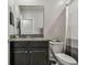 Bathroom featuring a single sink vanity with granite countertop, toilet and a shower curtain at 6825 Citrus Creek Ln, Tampa, FL 33625