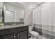 Stylish bathroom featuring granite counters and a modern shower curtain at 6825 Citrus Creek Ln, Tampa, FL 33625
