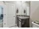 Bathroom featuring granite counters, a large mirror, and modern fixtures at 6825 Citrus Creek Ln, Tampa, FL 33625
