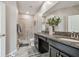 Bright bathroom featuring a double vanity with granite countertops and a glass enclosed shower at 6825 Citrus Creek Ln, Tampa, FL 33625