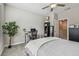 Bedroom showcasing a ceiling fan, a workspace area with desk and chair, and neutral decor throughout at 6825 Citrus Creek Ln, Tampa, FL 33625