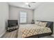 Bedroom featuring a patterned bedspread, a TV on a stand and a window with blinds at 6825 Citrus Creek Ln, Tampa, FL 33625