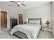 Cozy bedroom showcases a comfortable bed, soft carpet, neutral tones and an adjacent bathroom at 6825 Citrus Creek Ln, Tampa, FL 33625