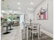 Bright dining area features a modern table, stylish rug, and open access to the living room and kitchen at 6825 Citrus Creek Ln, Tampa, FL 33625