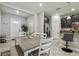 Inviting dining room showcases a wooden table, white chairs, and access to the kitchen and main entryway at 6825 Citrus Creek Ln, Tampa, FL 33625