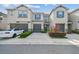 A charming two-story townhome featuring a gray garage, blue shutters, and inviting landscaping at 6825 Citrus Creek Ln, Tampa, FL 33625