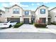 Charming townhome featuring a well-maintained lawn, a one-car garage, and stylish gray and blue accents at 6825 Citrus Creek Ln, Tampa, FL 33625