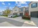 Charming townhome featuring a well-maintained lawn, a one-car garage, and stylish gray and blue accents at 6825 Citrus Creek Ln, Tampa, FL 33625