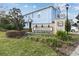 Charming blue townhome at Bridge Haven with well-manicured landscaping and attractive community signage at 6825 Citrus Creek Ln, Tampa, FL 33625