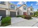 Charming townhome showcasing a well-maintained lawn, a one-car garage, and stylish gray and blue accents at 6825 Citrus Creek Ln, Tampa, FL 33625