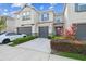 Charming townhome featuring a well-maintained lawn, a one-car garage, and stylish gray and blue accents at 6825 Citrus Creek Ln, Tampa, FL 33625