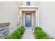 Stylish front door with stone accents and lush landscaping creates an inviting entrance to this lovely home at 6825 Citrus Creek Ln, Tampa, FL 33625