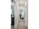 Carpeted hallway providing access to a bedroom and office space at 6825 Citrus Creek Ln, Tampa, FL 33625