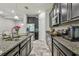 Well-equipped kitchen featuring granite counters, stainless appliances, dark cabinets and a view to the dining area at 6825 Citrus Creek Ln, Tampa, FL 33625