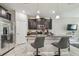 Modern kitchen featuring stainless steel appliances, granite countertops, stylish pendant lighting, and bar stool seating at 6825 Citrus Creek Ln, Tampa, FL 33625