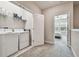 Laundry room with washer, dryer, and extra shelving is great for all your storage needs at 6825 Citrus Creek Ln, Tampa, FL 33625