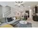 Cozy living room area offering a comfortable sofa, a plush rug, and an open view to the kitchen and dining areas at 6825 Citrus Creek Ln, Tampa, FL 33625