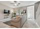 Inviting living room features a comfortable sofa, lots of natural light and an open view to the stairs at 6825 Citrus Creek Ln, Tampa, FL 33625