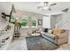 Comfortable living room features a large sofa, a plush rug, a TV, and ample natural light from the windows at 6825 Citrus Creek Ln, Tampa, FL 33625