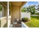 Cozy covered patio with seating and stylish blue patterned rug, perfect for outdoor relaxation at 6825 Citrus Creek Ln, Tampa, FL 33625
