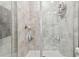 Close-up of a tiled shower with glass doors and built-in shelving for toiletries at 6825 Citrus Creek Ln, Tampa, FL 33625