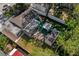 Aerial view of a private backyard oasis with a covered patio and lush greenery at 7003 Yule Ln, Tampa, FL 33637