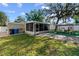 This backyard features outdoor living space with a grill and dining area, ideal for entertaining guests at 7003 Yule Ln, Tampa, FL 33637