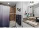 This bathroom boasts a shower-tub combination and granite countertop vanity with attractive finishes at 7003 Yule Ln, Tampa, FL 33637
