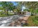 Inviting one-story home with a lengthy driveway, lush lawn, and mature trees offering ample shade at 7003 Yule Ln, Tampa, FL 33637