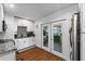 Well-appointed kitchen featuring double doors to the outside, gray backsplash, and granite countertops at 7003 Yule Ln, Tampa, FL 33637