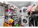 Functional laundry room features shelving and stacked washer and dryer for convenient chore management at 7003 Yule Ln, Tampa, FL 33637