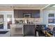 Functional outdoor kitchen features stainless steel cabinets, appliances, and modern conveniences at 7003 Yule Ln, Tampa, FL 33637
