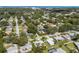Neighborhood aerial view with a beautiful skyline, trees, and single Gathering homes with pools at 709 Pinewood Dr, Dunedin, FL 34698