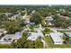 Neighborhood aerial view with a beautiful skyline, trees, and single Gathering homes with pools at 709 Pinewood Dr, Dunedin, FL 34698