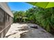This outdoor area features green umbrellas and palm trees, creating a tropical backyard oasis at 709 Pinewood Dr, Dunedin, FL 34698