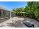 Private backyard offering lush tropical landscaping, a travertine paver patio, and a quiet outdoor retreat at 709 Pinewood Dr, Dunedin, FL 34698